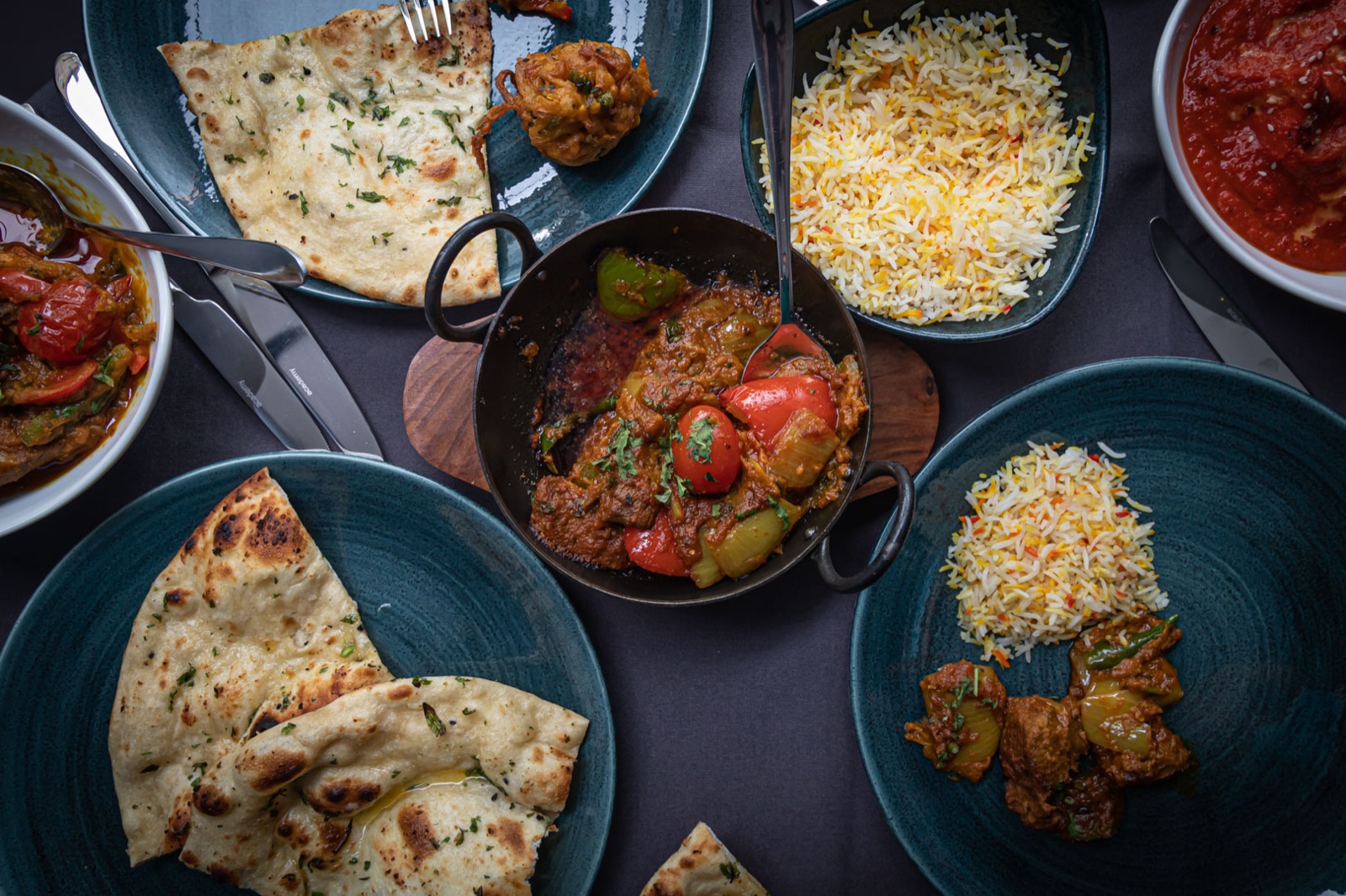 A spread of Bo&rsquo;ness Spice curries, rice and breads photographed from above